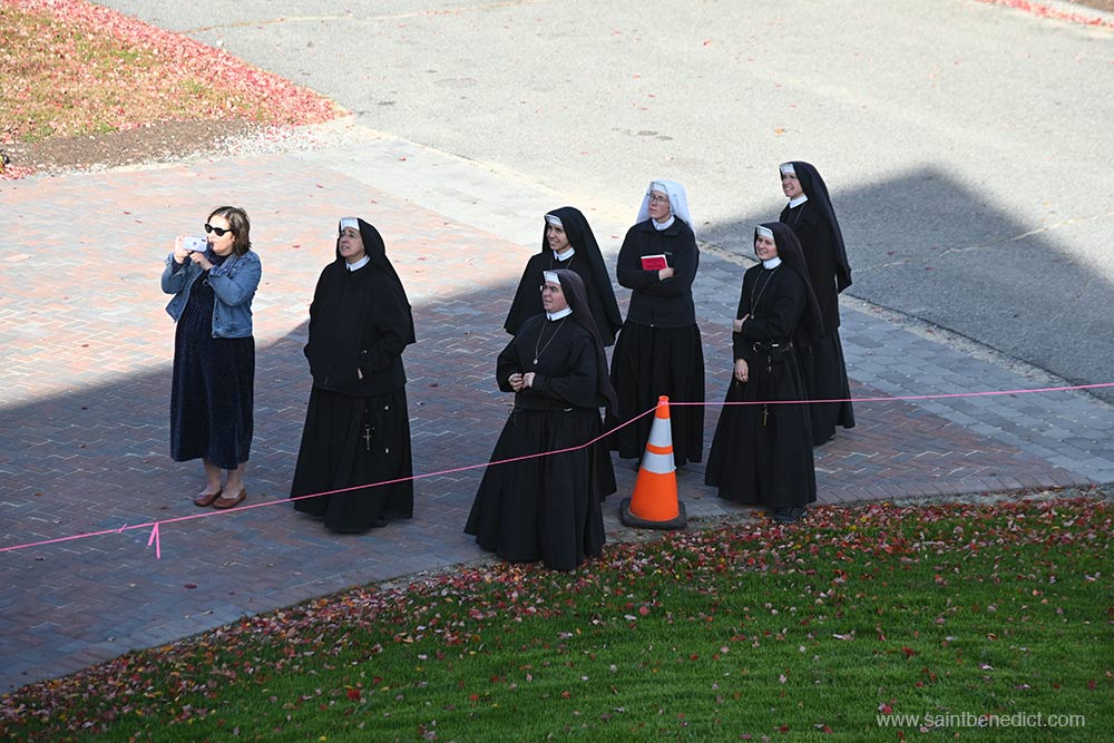 Sisters watch as the statue is raised. Sisters watch as the statue is raised.