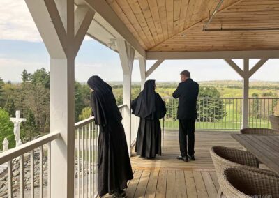 Bishop McManus enjoys chatting with Sister on the refectory deck.