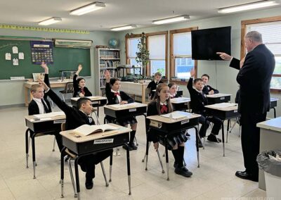 Fourth graders eagerly answer questions.
