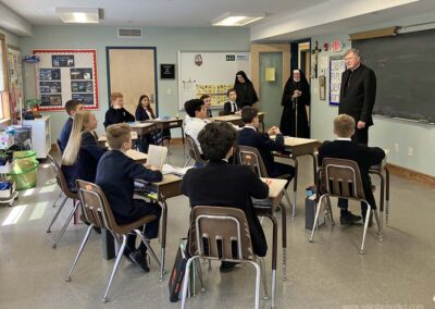 IHM 6th graders chat with the bishop