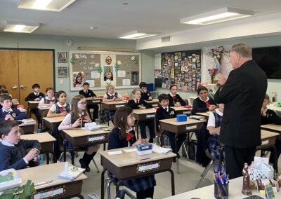 5th graders listen as the Bishop speaks.