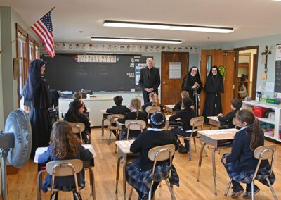 First Graders listen as the bishop speaks.