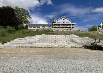 Retaining wall that will become the Lourdes Grotto at Saint Benedict Center begins, June 2026.